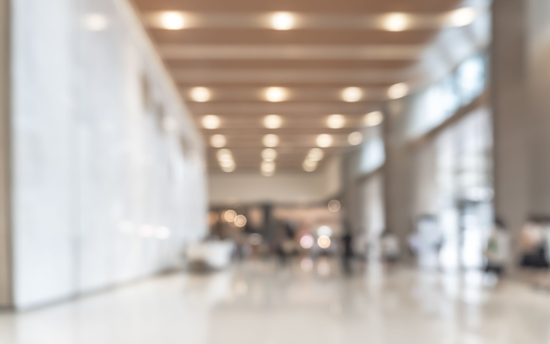 Blurred office building lobby or hotel blur background interior view toward reception hall, modern luxury lounge, white room space with blurry corridor and building glass wall Blurred office building lobby or hotel blur background interior view toward reception hall, modern luxury lounge, white room space with blurry corridor and building glass wall